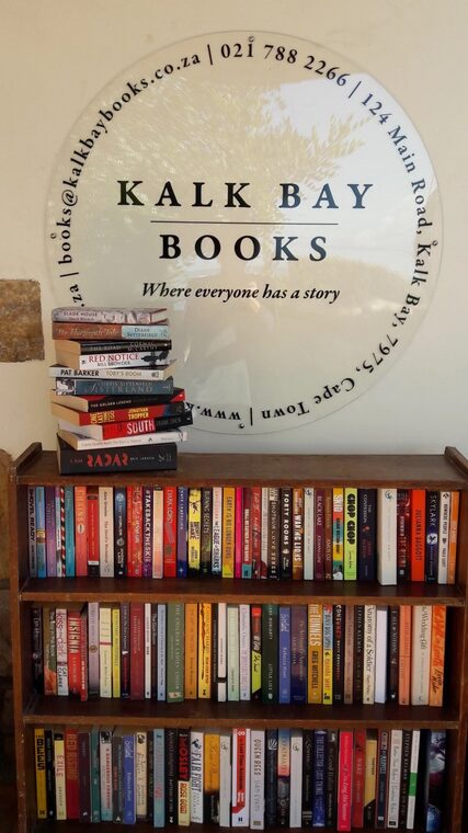 Kalk Bay Books — its round sign above a shelf of books.